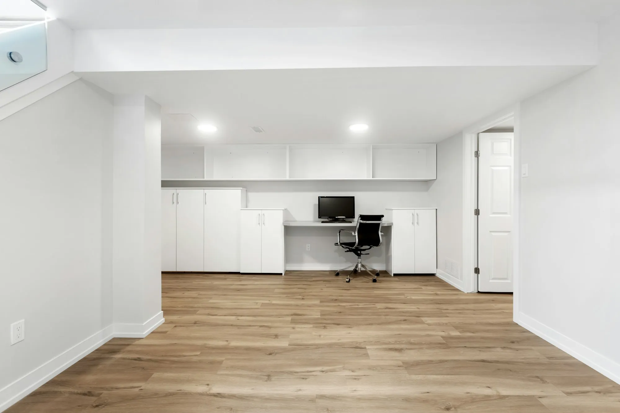 Finished basement family room with sectional sofa and recessed lighting